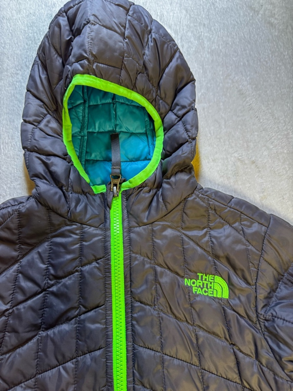 The North Face Black Hooded kids Puffer Jacket with Neon Green Accents